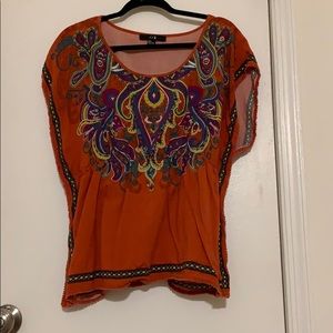Orange t shirt with elastic synch in middle.